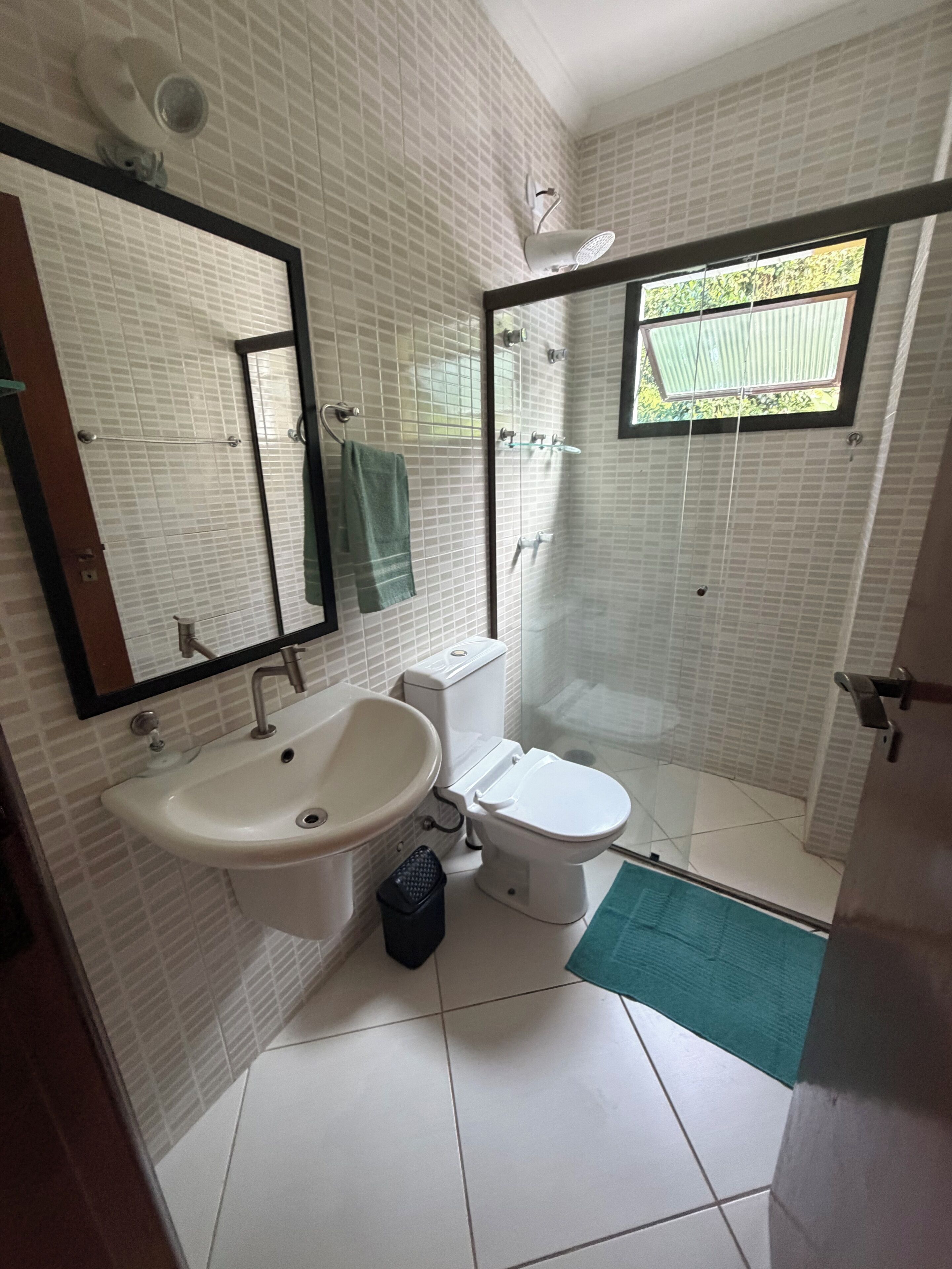 A bathroom with a sink, toilet, and shower.