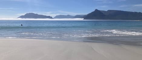 A beach with a clear sky and calm sea.