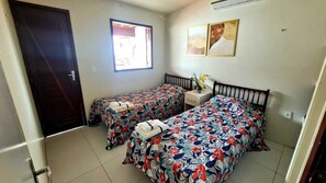 A room with two beds, a window, a nightstand, and a door. - Retreat in Maragogi: 4 Bedrooms | Space & Leisure (Barra Grande)