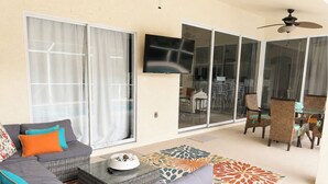 A living room with a sofa, a coffee table, and a patterned rug. - Private Heated Pool, Sleeps 10, King Suite, Near Dining and Boating (Cape Coral)