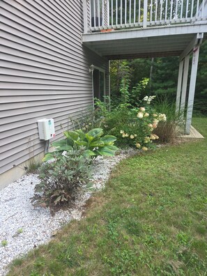 A residential exterior with a covered porch, a utility box, and a gravel pathway. - Luxury Woodland Retreat Game Room Sleeps 6 Near Providence (Scituate)