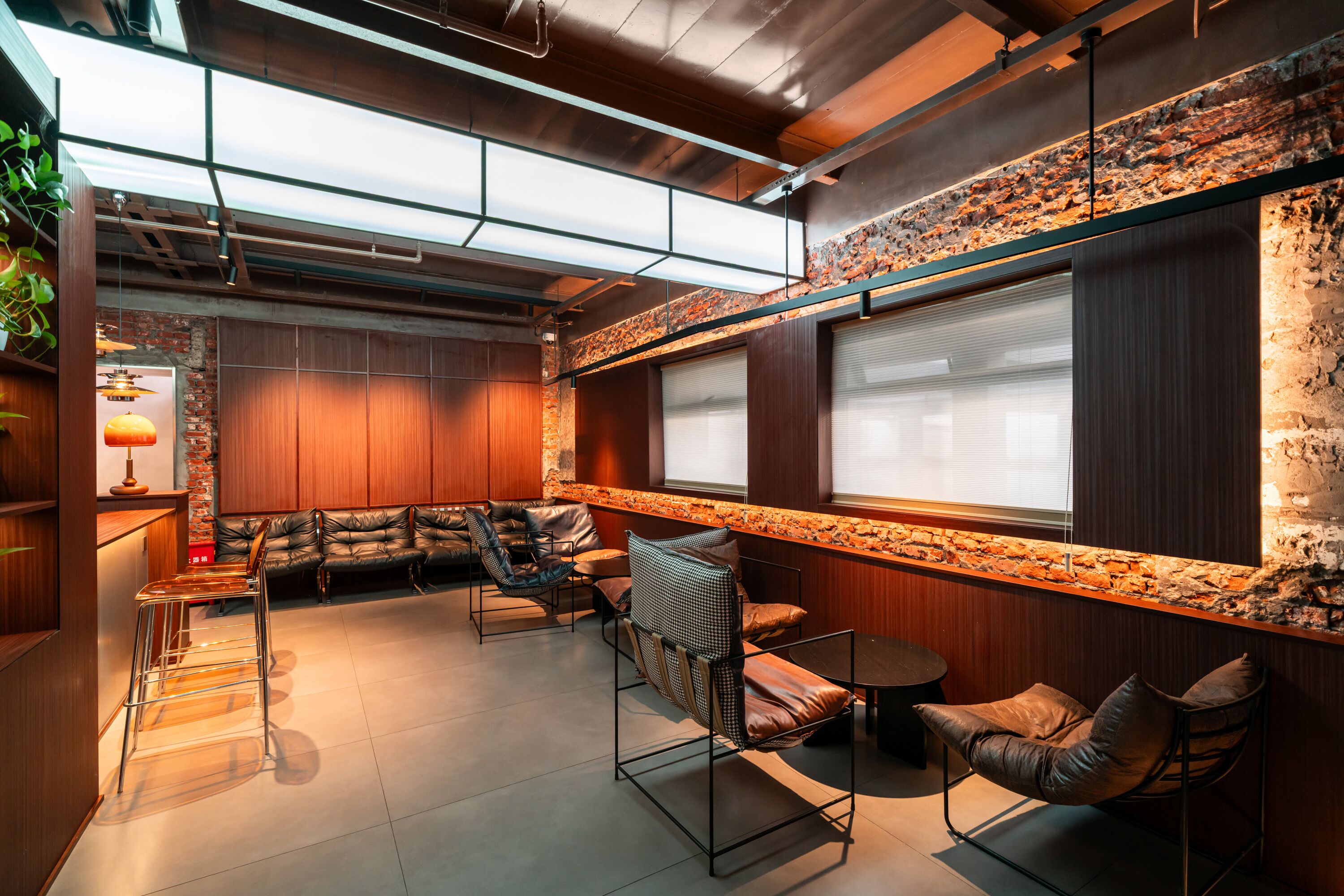 A modern interior with a seating area, wooden walls, and a stone accent wall.