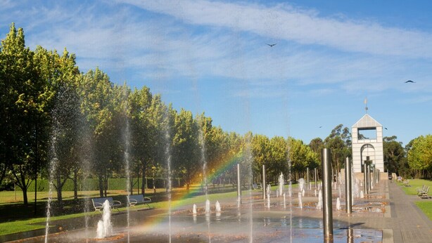 A park with a fountain, a rainbow, and a monument. - Sydney Olympic Park View Bliss | Modern Design (Sydney Olympic Park)