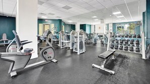 A gym with various exercise equipment, including treadmills, weight machines, and dumbbells. - Haven Beach Gem Condo in Hollywood (Hollywood)