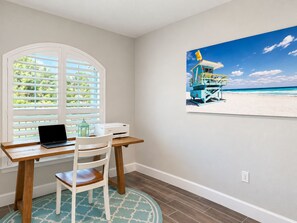 A room with a desk, chair, and a beach scene painting on the wall. - 3BR Pool & Hot Tub Villa in Rotonda West (Rotonda West)