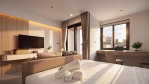 A modern hotel room with a bed, a desk, a TV, and a city view. - Brio Elara Hotel And Apartment (Da Nang)