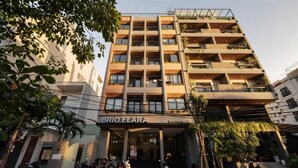 A multi-story building with a storefront named 'BRIO ELARA' at the ground level. - Brio Elara Hotel And Apartment (Da Nang)