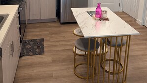 A modern kitchen with a stainless steel refrigerator, white cabinets, and a marble countertop. - Cozy 1-bedroom apartment in pleasant Hollywood  Downtown ,pool and gym access. (Hollywood)