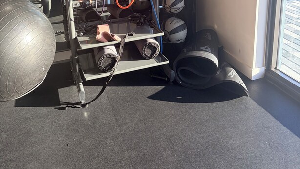 A gym with exercise equipment, including a cable machine and medicine balls. - Cozy 1-bedroom apartment in pleasant Hollywood  Downtown ,pool and gym access. (Hollywood)
