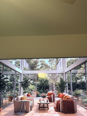 A modern living room with large windows, a sofa set, and a coffee table. - Cozy 1-bedroom apartment in pleasant Hollywood  Downtown ,pool and gym access. (Hollywood)