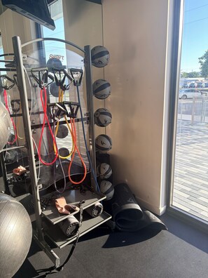 A gym with exercise equipment, including a rowing machine and multiple exercise balls. - Cozy 1-bedroom apartment in pleasant Hollywood  Downtown ,pool and gym access. (Hollywood)