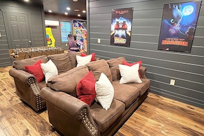 A seating area with a brown sofa set and a foosball table. - Indoor Pool, Arcade, Theater, Hot Tub, 50% off Zipline (Sevierville)