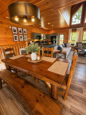 A spacious wooden interior with a dining area, kitchen, and living space. - Indoor Pool, Arcade, Theater, Hot Tub, 50% off Zipline (Sevierville)