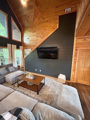 A cozy living room with a sofa set, a coffee table, and a fireplace. - Indoor Pool, Arcade, Theater, Hot Tub, 50% off Zipline (Sevierville)