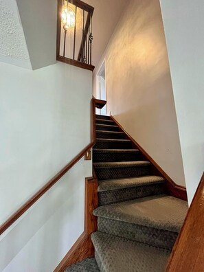 A staircase with wooden handrails and carpeted steps leading to a landing. - Beautiful 3BR semi detached (entire) home in Brampton (Brampton)