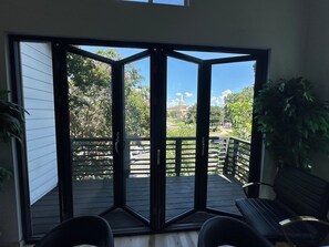 A room with a sliding glass door leading to an outdoor deck.