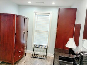 A bathroom with a wooden wardrobe, a towel rack, a sink with a mirror, and a window with blinds. - 6 Bedroom/6 Bathroom Dog Friendly Wisconsin Dells 13 min, Cascade Ski Hill 6min (Portage)