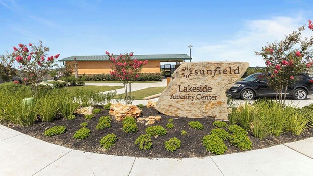 A sign for the Sunfield Lakeside Amenity Center with a building in the background. - 3BR Sanctuary: Clean, Cozy & Complete with Pools and 20 min to DT Austin (Mustang Ridge)