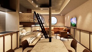 Um interior moderno com uma cama beliche, uma janela redonda, um sofá e uma televisão na parede.