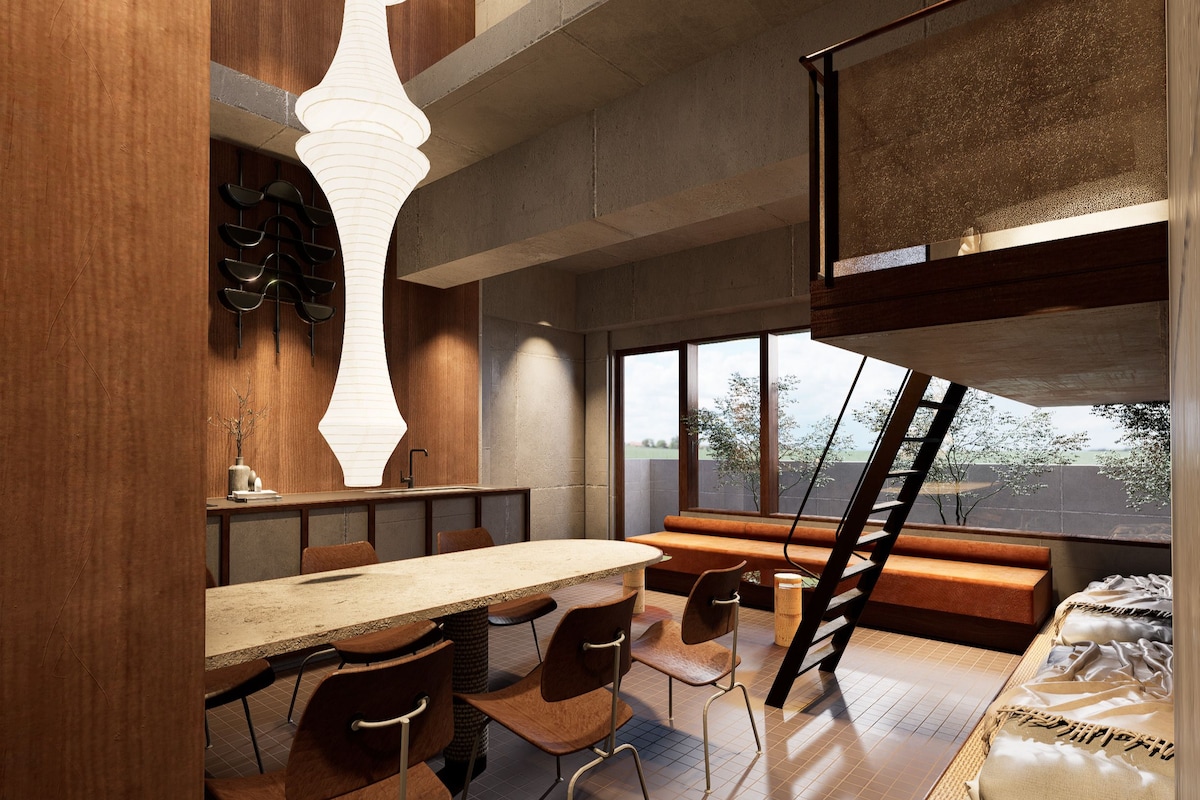 Un intérieur moderne comprenant un coin repas, un escalier et une vue sur l’extérieur.