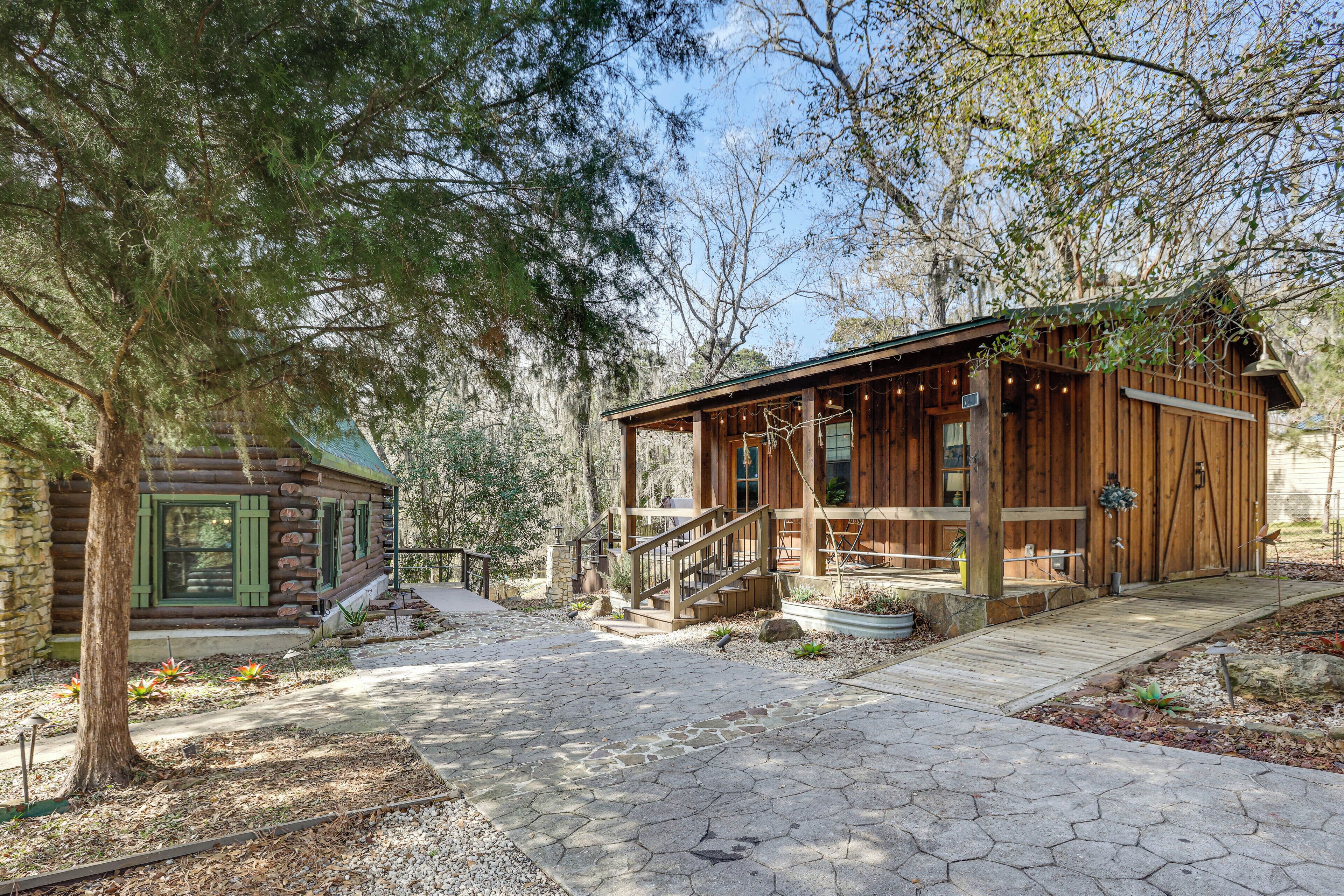 A rustic cabin with a wooden exterior, a stone foundation, and a wooden deck leading to the entrance.