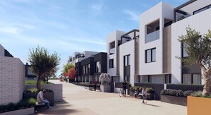 A modern residential building with a flat roof, large windows, and a paved walkway. - New large 3BR,3bathrms townhouse in Gunghalin, mountain views,central location (Gungahlin)