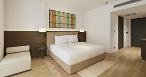 Ein modernes Hotelzimmer mit einem großen Bett, Nachttischen, einem Wandbild und einer Tür zu einem weiteren Raum.