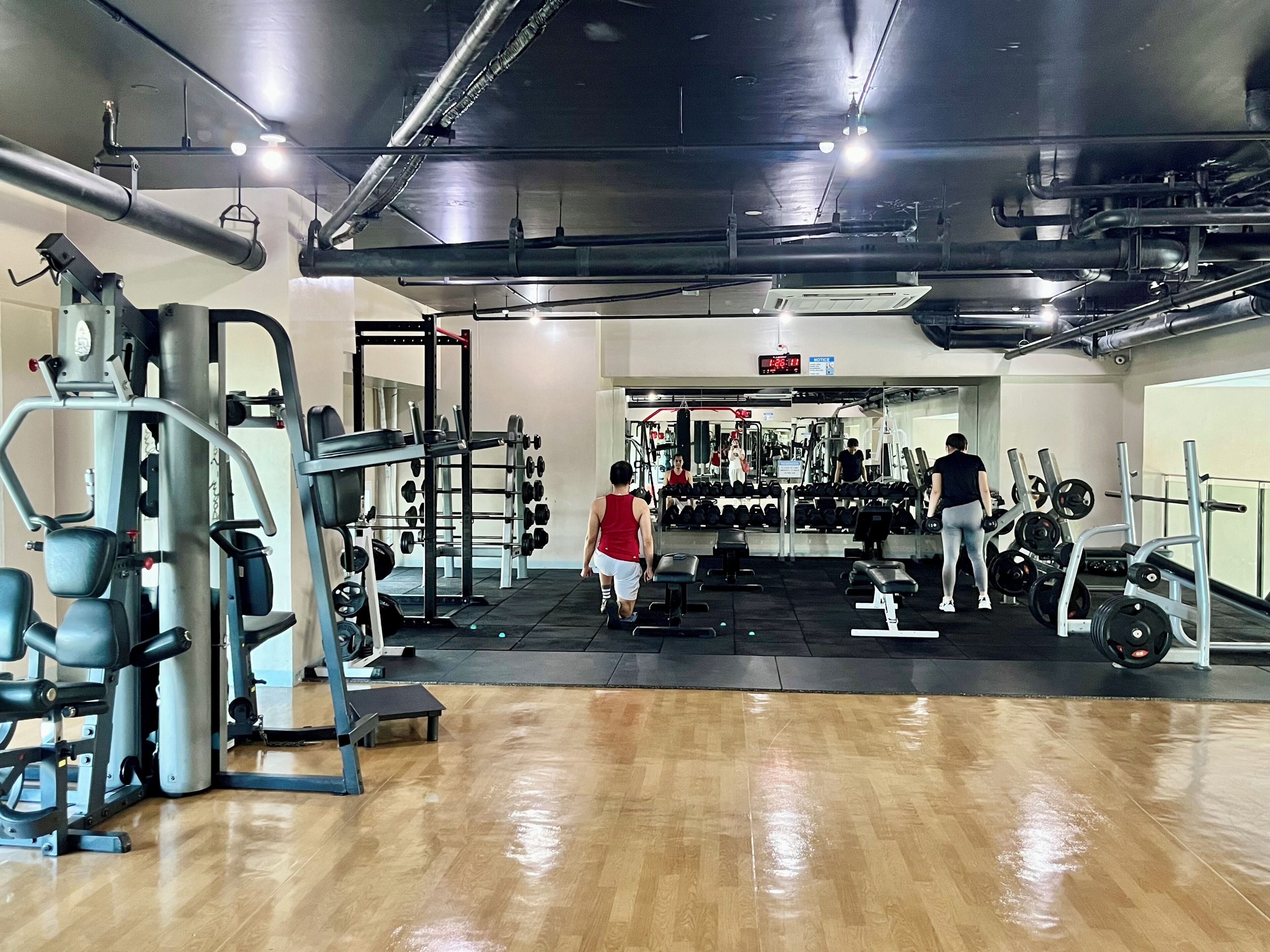 A gym with various exercise equipment, including weight machines and free weights.