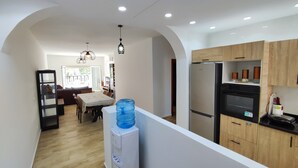 A modern kitchen with a built-in refrigerator, wooden cabinets, and a water dispenser. - Beachfront apartment with a terrace and ocean view (Marina Saidia)