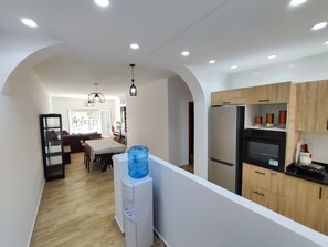 A modern kitchen with a built-in refrigerator, wooden cabinets, and a water dispenser. - Beachfront apartment with a terrace and ocean view (Marina Saidia)