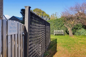 A wooden gate with a sign reading 'Apt 2 Sea Blue RETREAT.' - Sea Blue Retreat 2-Bed Unit in Glenelg North (Glenelg North)
