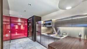 A modern kitchen with stainless steel appliances, a wooden countertop, and a red cabinet. - Cozy studio with AC in serene Las Vegas location (Las Vegas)