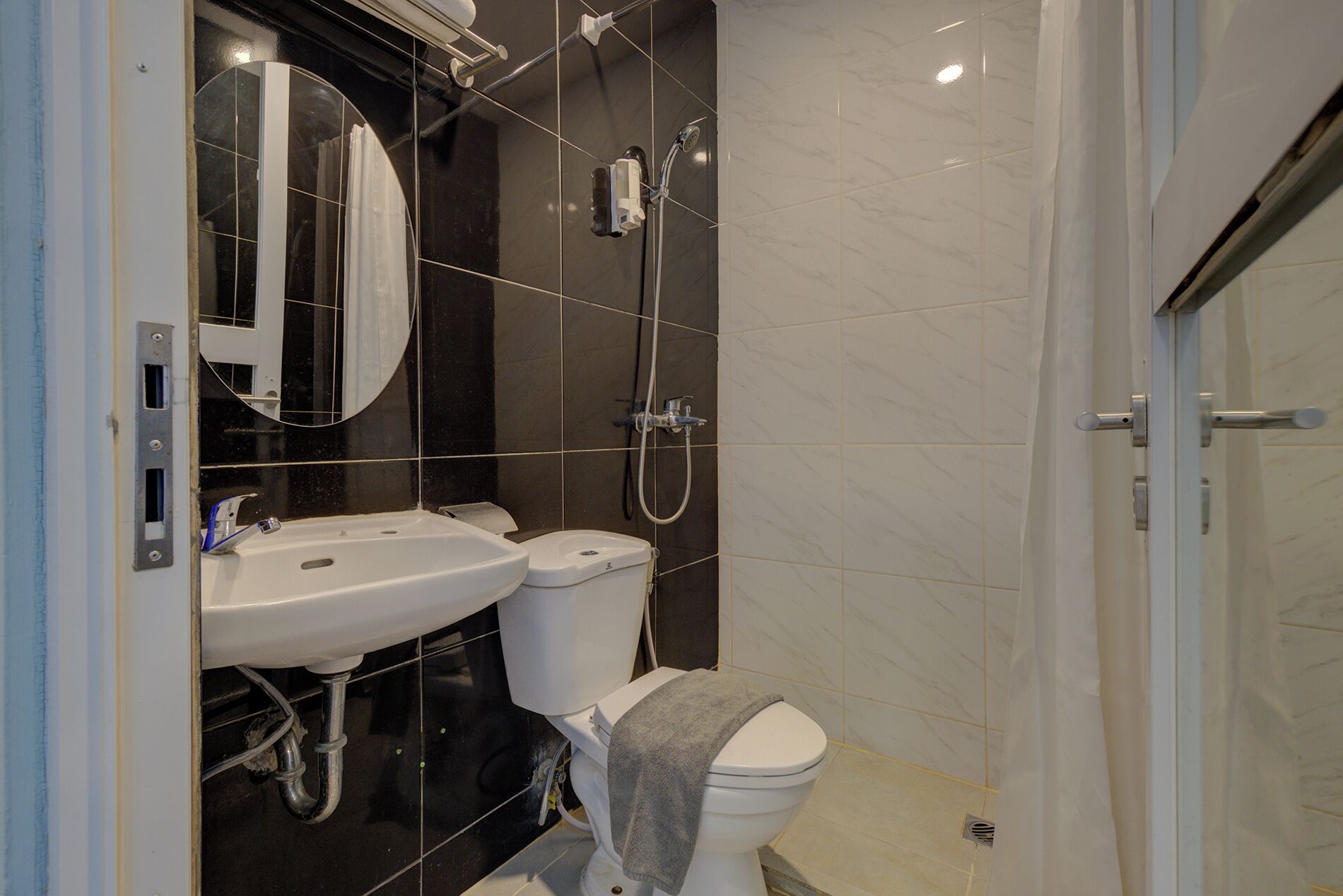 A modern bathroom with a shower, toilet, and sink.