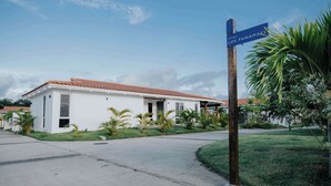 A residential building with a white facade and a red-tiled roof. - Family Surf Villa with Resort Amenities at Venao (Las Escobas del Venado)