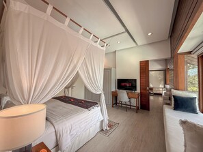 A bedroom with a canopy bed, a desk with a TV, and a sofa. - Villa Batu Sari - A Serene Luxury Retreat in the Heart of Canggu (Badung)