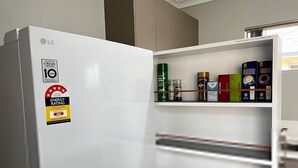 A white LG refrigerator with a 10-year warranty and an energy rating of 286.