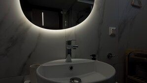 A modern bathroom with a round sink, a mirror, and a towel rack. - Antonio Airport Loft-FREE AIRPORT SHUTLE (Markopoulo Mesogeas)