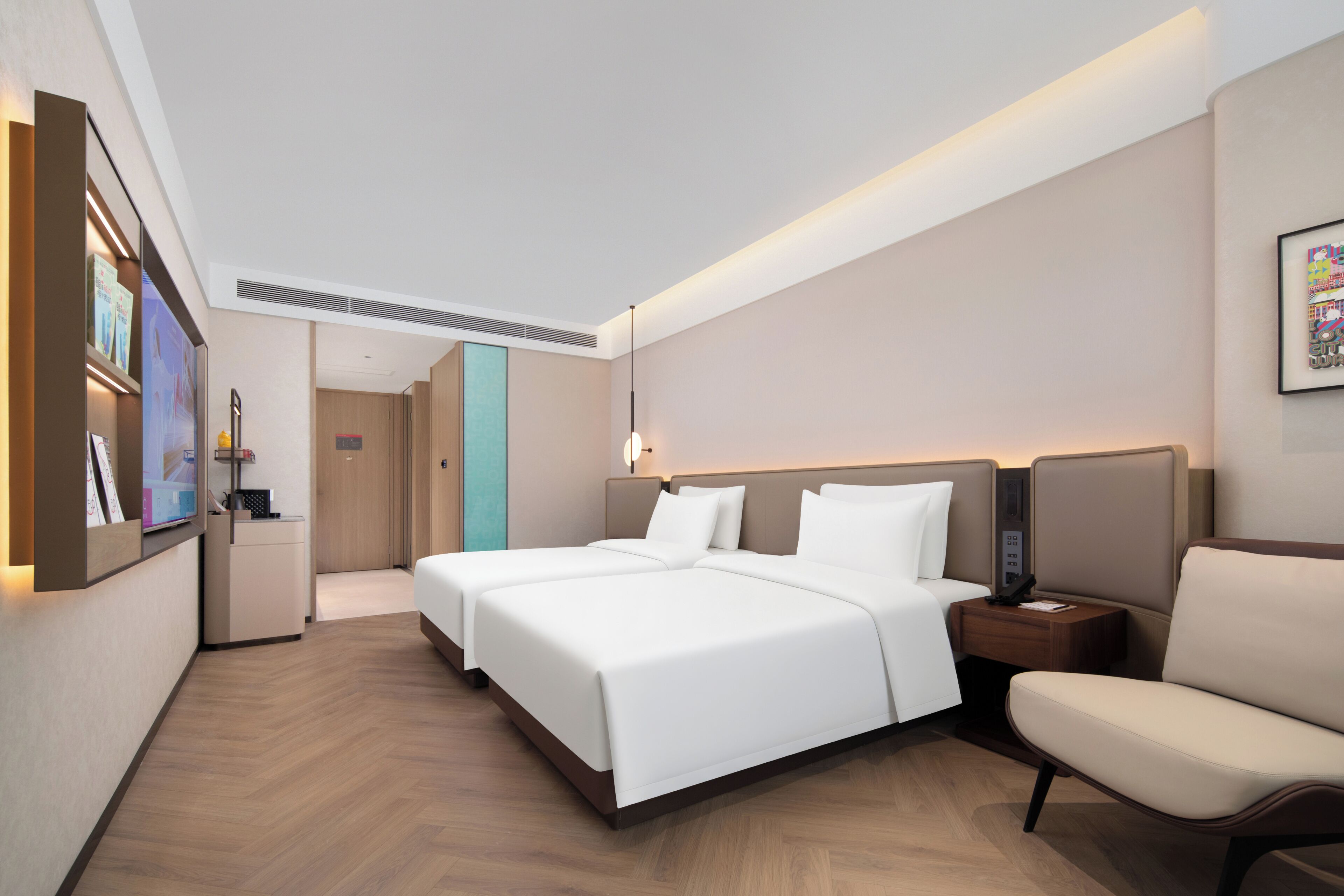 Habitación de hotel con una cama grande, mesitas de noche, una silla y un televisor.