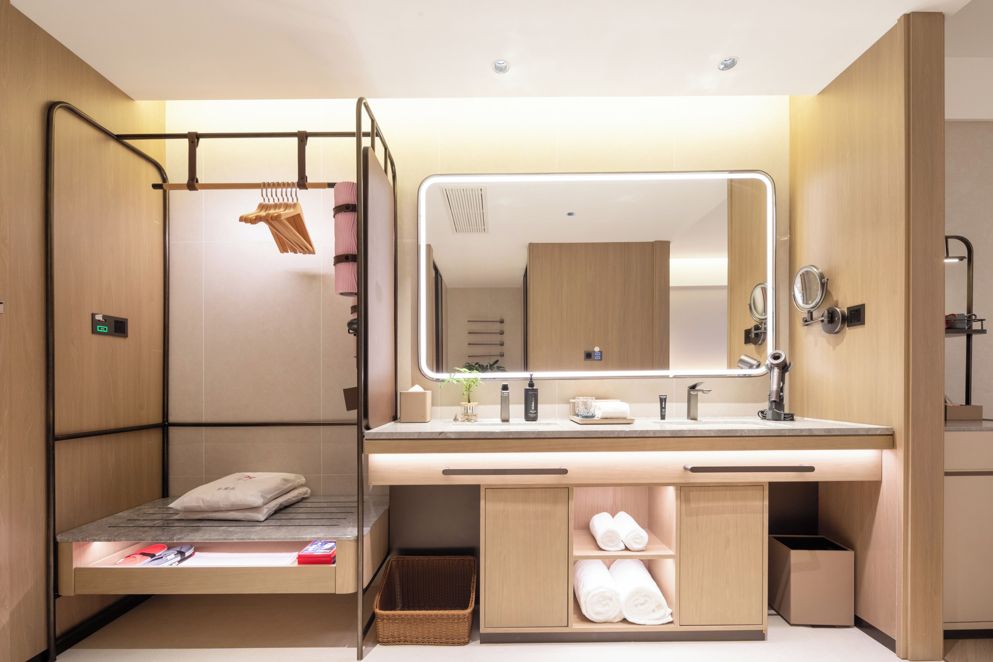 A modern bathroom with a built-in shower, a large mirror, and a vanity with a sink.