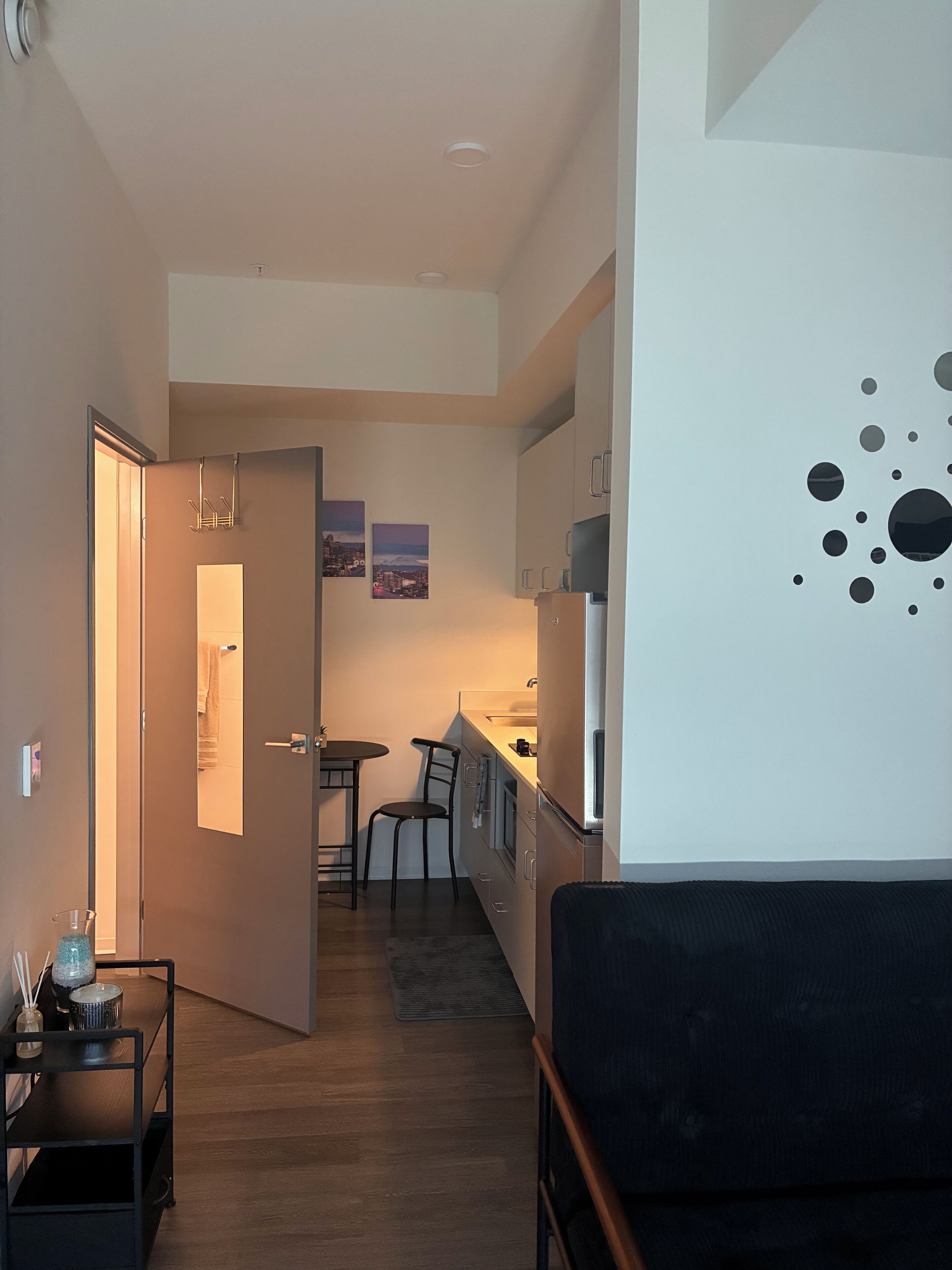 A compact living space with a kitchenette, a dining area, and a seating area.