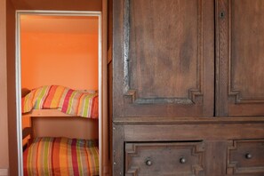 A wooden wardrobe with a mirrored door and a small drawer. - Large holiday home with a swimming pool in Le Var (Collobrieres)