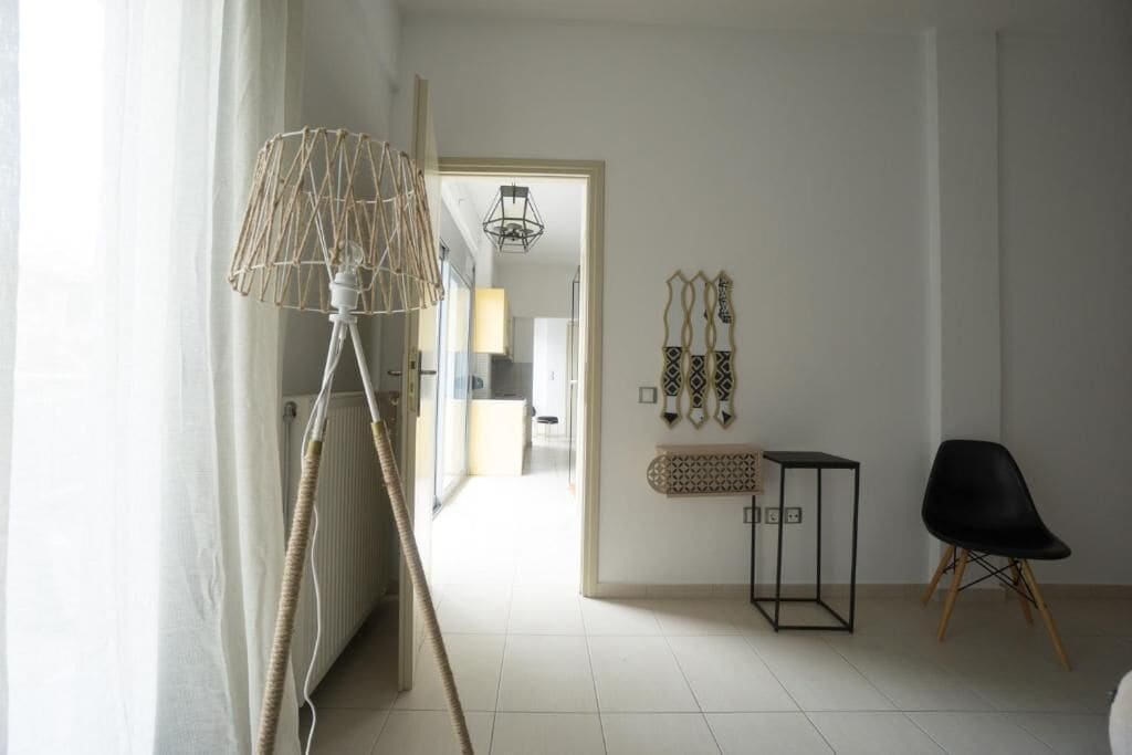 A room with a radiator, a lamp, a chair, and wall decorations.