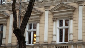Une façade de bâtiment ornée d’éléments architecturaux classiques, notamment des colonnes et des moulures décoratives.