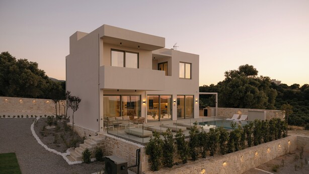 A modern two-story house with a swimming pool, stone walls, and a well-maintained garden. - Lynx Villa, Heated Pool, Walk to Shops & Dining (Rethymno)
