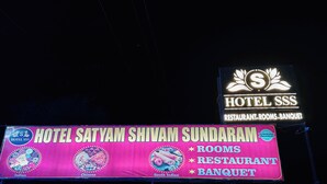A hotel sign with 'Hotel SSS' and 'Hotel Satyam Shivam Sundaram' indicating the name and services offered.