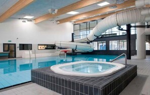 An indoor swimming pool with a hot tub, wooden beams on the ceiling, and a large window. - Gorgeous home in Farsø with WiFi (Farsø)