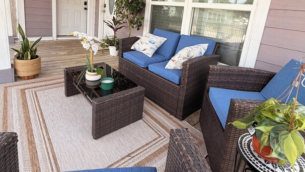 A covered porch with wicker furniture, a white door, and a large window. -         Modern 2BR- gated Duplex -Sleeps 7 - Free Parking - Near Downtown (Houston)