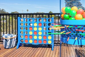 A blue game board with numbered slots and a basket of colorful balls. - Santa Cruz Escape-Rooftop Deck/Ocean Views/Hot Tub (Santa Cruz)