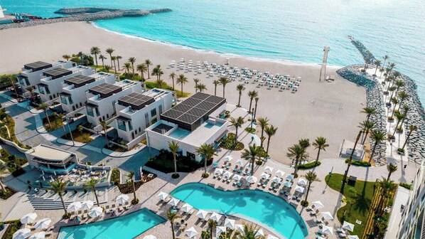 A resort with multiple buildings, a swimming pool, and a beach. - Bloomfields 2BR + Maid Address Residences Fujairah (Al Aqah)