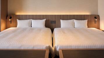A double bed with a wooden headboard and two bedside tables.